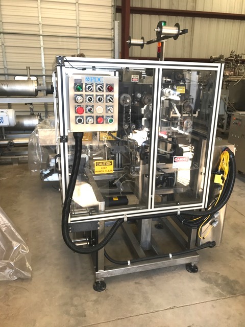 ***SOLD*** Used PDC 65-E Shrink Sealer Tamper Evident Band Applicator. Ideal for mid-level speed tamper evident banding or shrink sleeve applicator. Output: up to approximately 200 containers per minute, depending on container and band size. Tamper evident banding: Band diameter range:  .375 to 3.25 inches.  Band height range: .625 to 8 inches. Line speed:  50 to 200 containers per minute. Shrink sleeve labeling: Sleeve diameter range: .375 to 3.25 inches. Sleeve height range:  .625 to 8 inches. Line speed:  50 to 175 containers per minute.